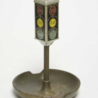 Photo of a Traffic light ash tray. Indications read "WE'RE 20 IN '40 AND GOING LIKE 60"