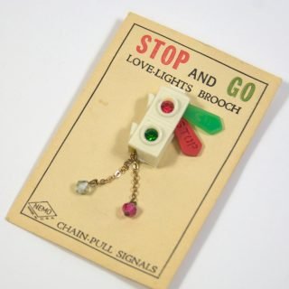 Semaphore brooch in packaging (rounder beads)