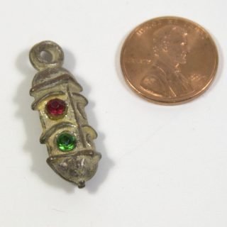 Two-sided red-green silver-over-copper-over-plastic Cracker Jack or gum ball machine prize