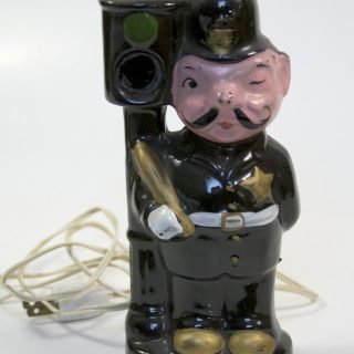 Photo of a Ceramic police officer and 120-volt traffic light lamp
