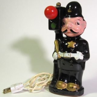 Ceramic policeman and signal with working red light bulb and painted ceramic green section