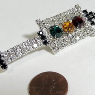 Rhinestone-covered red-yellow-green brooch