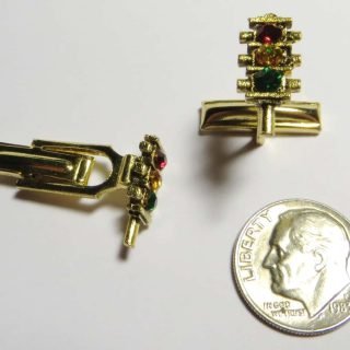 Gold tone three section flat 4-way cufflinks with rhinestone lenses