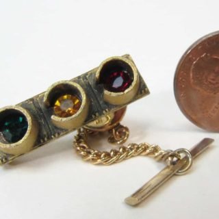 Tie tack and chain with red, yellow, and green rhinestones