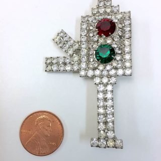 Rhinestone-covered red-green brooch