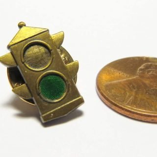 Flat brass two section traffic light pin with painted green indication
