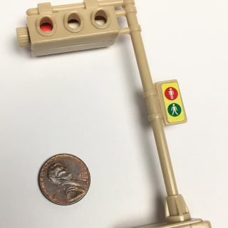 Beige plastic horizontal adjustable traffic signal with pedestrian signal as a sticker
