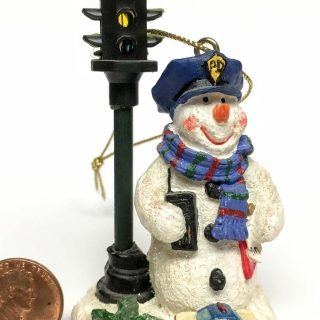 Snowman police officer next to 4-way traffic light Christmas ornament
