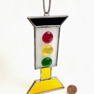 Hanging glass sun-catcher with black top and yellow base and stand