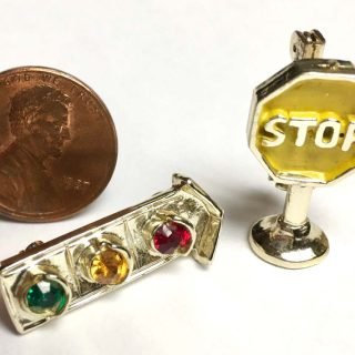 Traffic light with gem stones and yellow stop sign pins