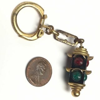 Black 4-way 2-section traffic light key chain likely from the 1960s or 70s.