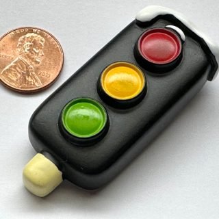 Black traffic light fridge magnet with snow on top